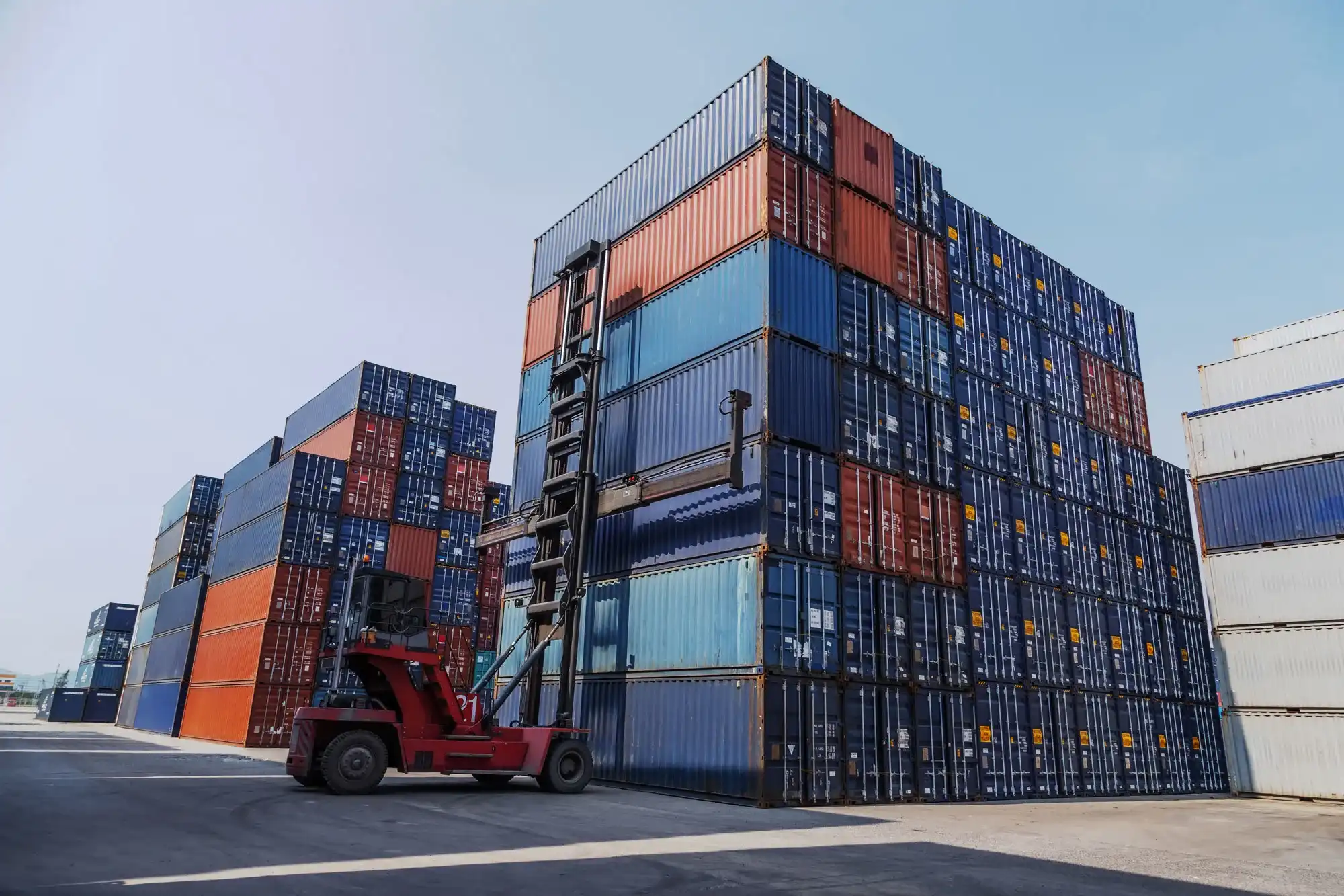 Shipping containers being moved in a logistics yard